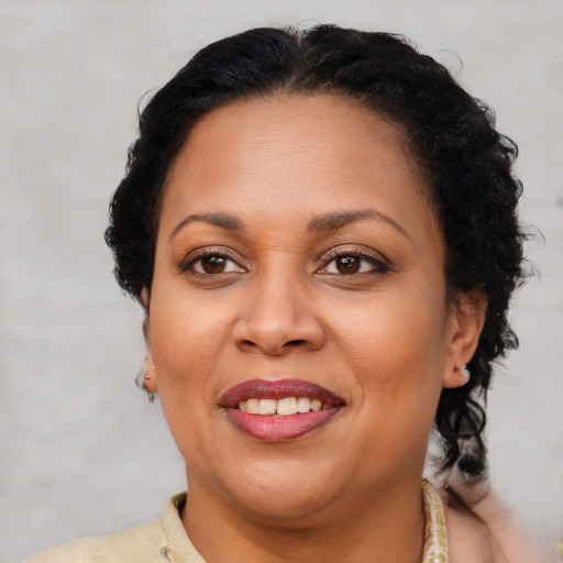 Joyful latino adult female with short  brown hair and brown eyes