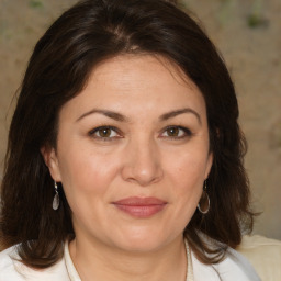 Joyful white adult female with medium  brown hair and brown eyes