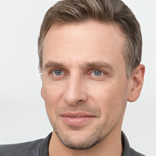 Joyful white adult male with short  brown hair and grey eyes