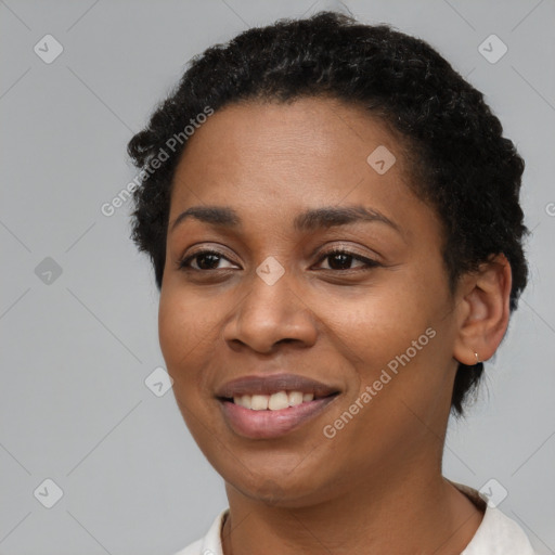 Joyful black young-adult female with short  black hair and brown eyes