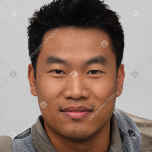 Joyful asian young-adult male with short  black hair and brown eyes