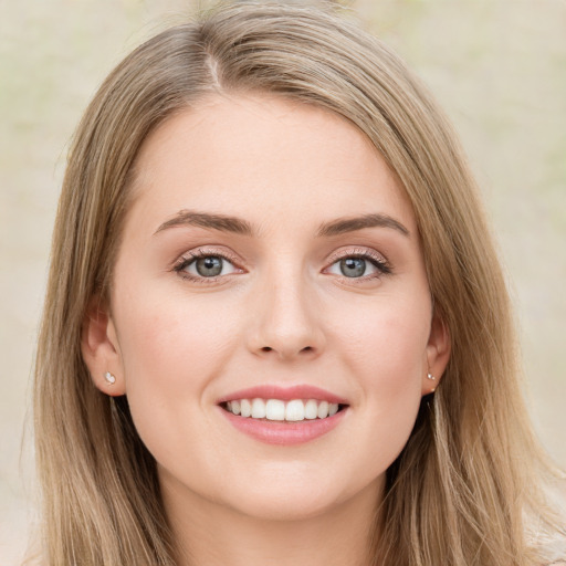 Joyful white young-adult female with long  brown hair and green eyes