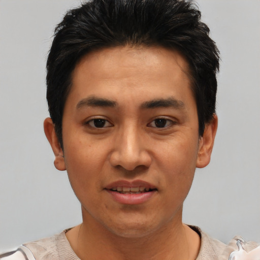 Joyful asian young-adult male with short  black hair and brown eyes