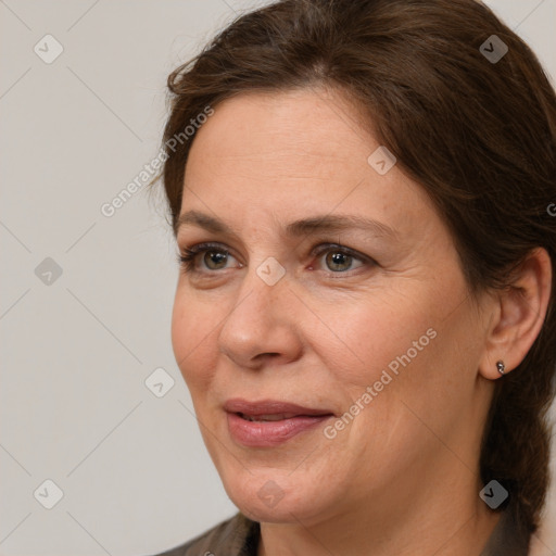 Joyful white adult female with medium  brown hair and grey eyes