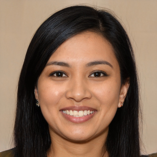 Joyful latino young-adult female with long  black hair and brown eyes