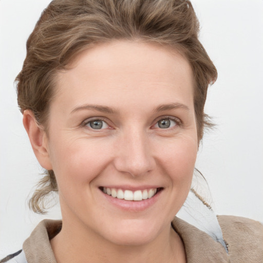 Joyful white young-adult female with short  brown hair and grey eyes