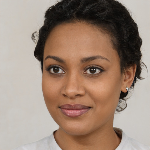 Joyful latino young-adult female with short  brown hair and brown eyes