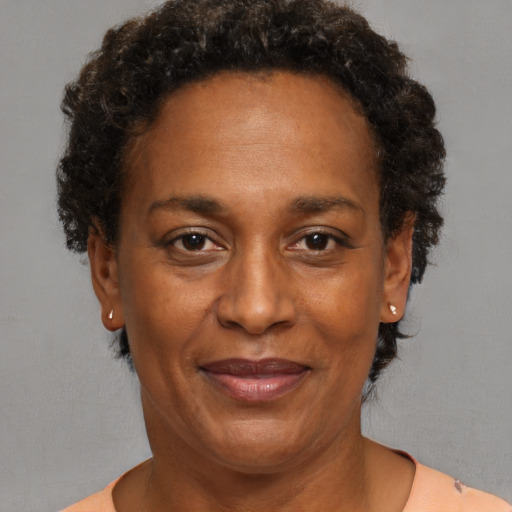 Joyful black adult female with short  brown hair and brown eyes