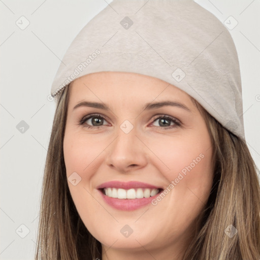 Joyful white young-adult female with long  brown hair and brown eyes