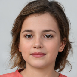 Joyful white child female with medium  brown hair and brown eyes