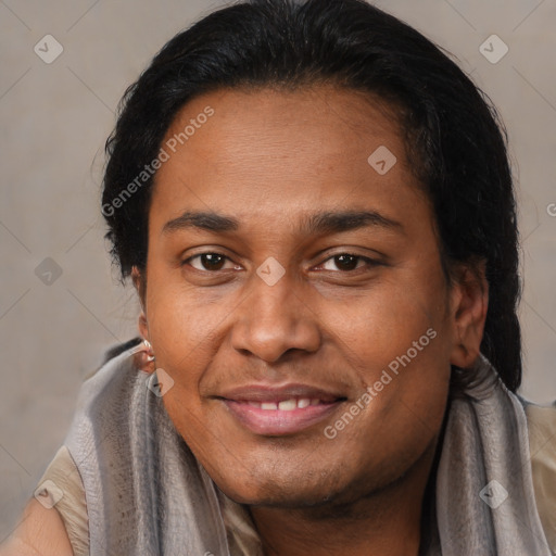 Joyful latino adult male with short  brown hair and brown eyes