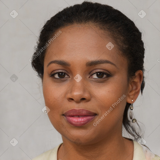 Joyful black young-adult female with long  brown hair and brown eyes