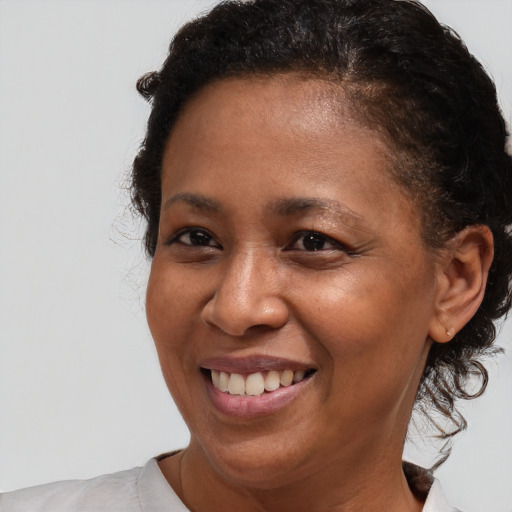 Joyful black adult female with short  brown hair and brown eyes