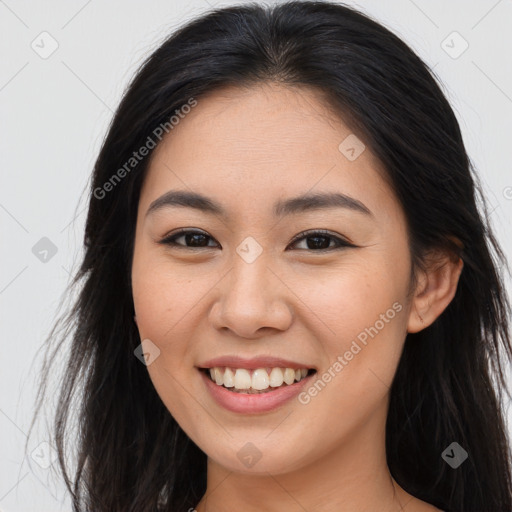 Joyful asian young-adult female with long  brown hair and brown eyes