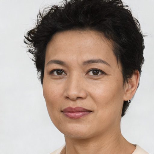 Joyful asian adult female with short  brown hair and brown eyes