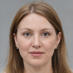 Joyful white adult female with long  brown hair and brown eyes