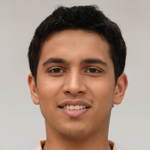Joyful latino young-adult male with short  brown hair and brown eyes