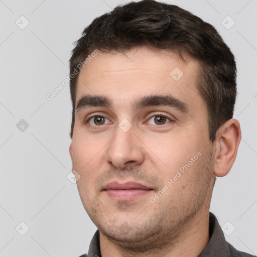 Joyful white young-adult male with short  black hair and brown eyes