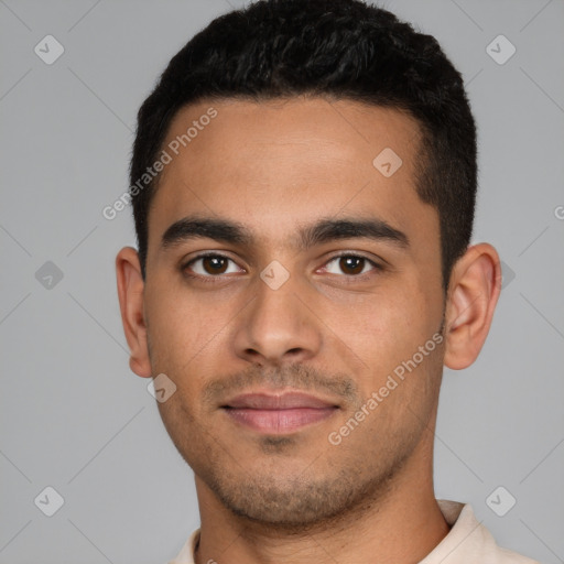 Joyful latino young-adult male with short  black hair and brown eyes