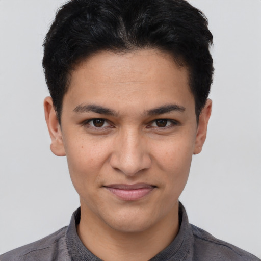 Joyful white young-adult male with short  black hair and brown eyes