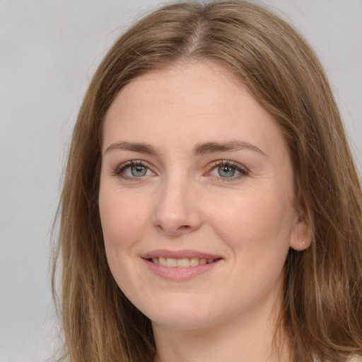 Joyful white young-adult female with long  brown hair and grey eyes