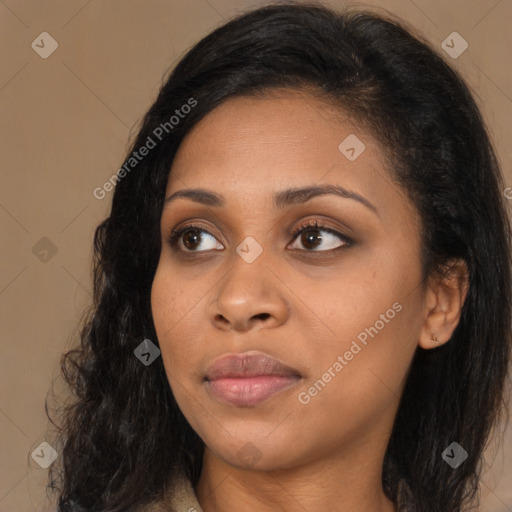 Joyful black young-adult female with long  black hair and brown eyes