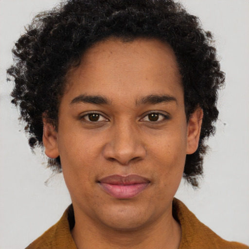 Joyful black adult female with short  brown hair and brown eyes