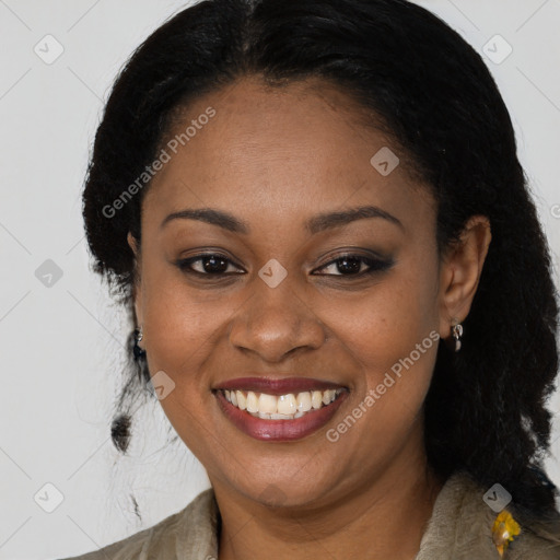 Joyful black young-adult female with long  black hair and brown eyes