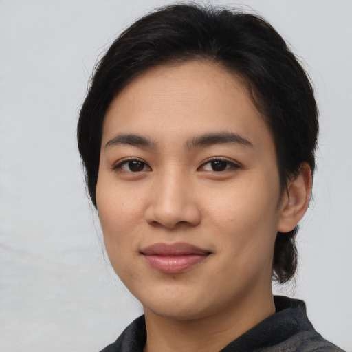 Joyful asian young-adult female with medium  brown hair and brown eyes