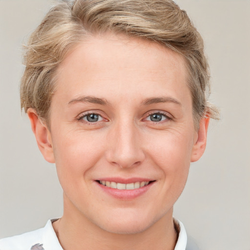 Joyful white young-adult female with short  brown hair and grey eyes