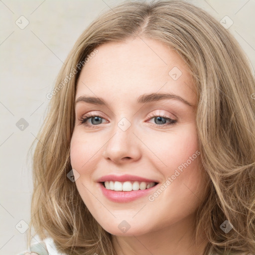 Joyful white young-adult female with long  brown hair and green eyes