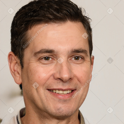 Joyful white adult male with short  brown hair and brown eyes