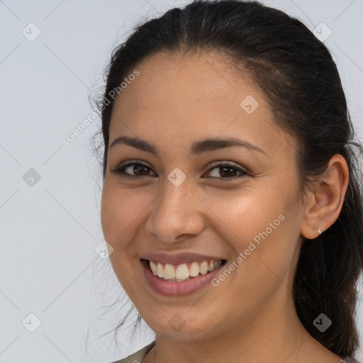 Joyful latino young-adult female with long  brown hair and brown eyes