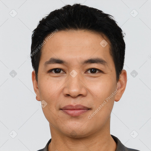 Joyful asian young-adult male with short  black hair and brown eyes