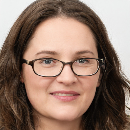 Joyful white young-adult female with long  brown hair and blue eyes