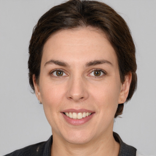 Joyful white young-adult female with medium  brown hair and grey eyes