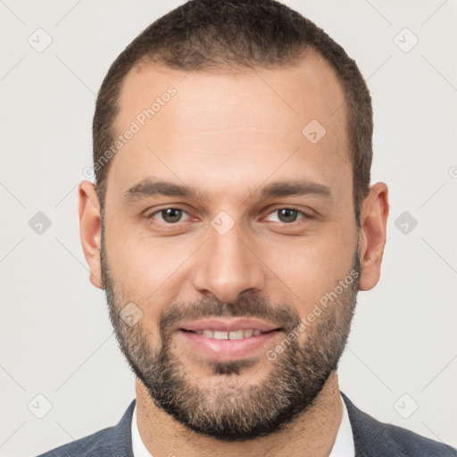 Joyful white young-adult male with short  brown hair and brown eyes