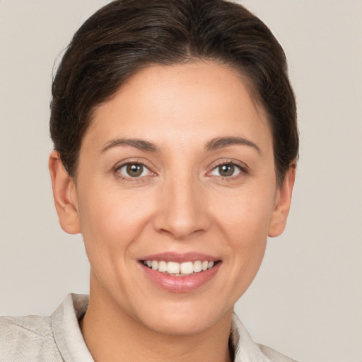 Joyful white young-adult female with short  brown hair and brown eyes