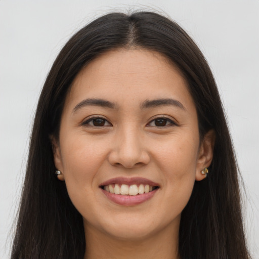 Joyful white young-adult female with long  brown hair and brown eyes