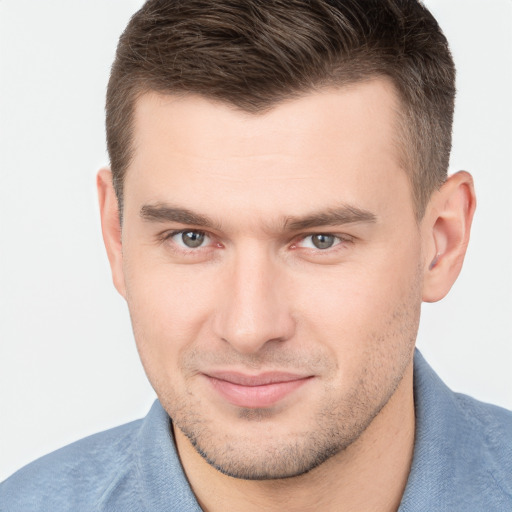 Joyful white young-adult male with short  brown hair and brown eyes