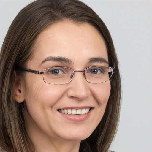 Joyful white adult female with long  brown hair and brown eyes