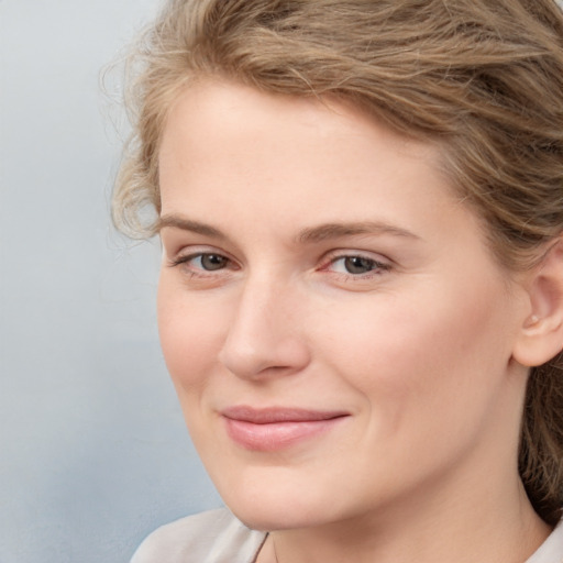 Joyful white young-adult female with medium  brown hair and blue eyes