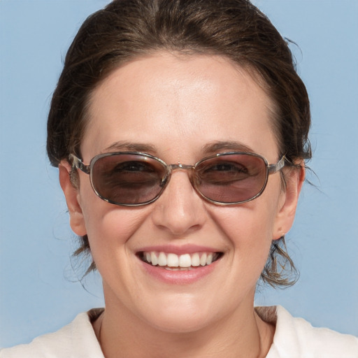 Joyful white young-adult female with medium  brown hair and blue eyes