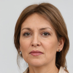 Joyful white adult female with medium  brown hair and grey eyes