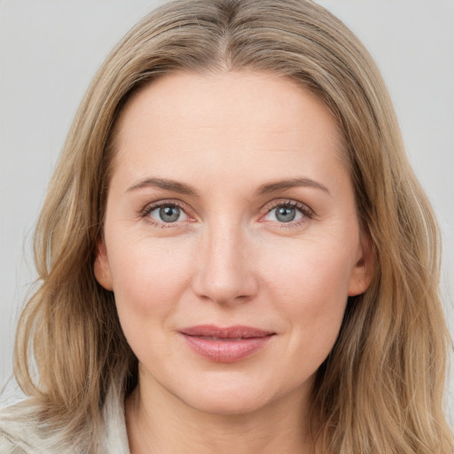 Joyful white young-adult female with medium  brown hair and blue eyes