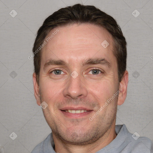 Joyful white adult male with short  brown hair and grey eyes