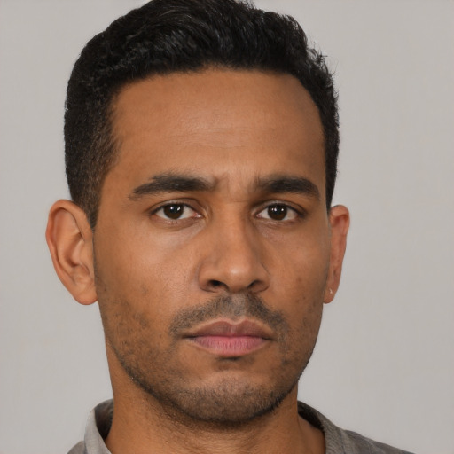 Neutral latino young-adult male with short  black hair and brown eyes