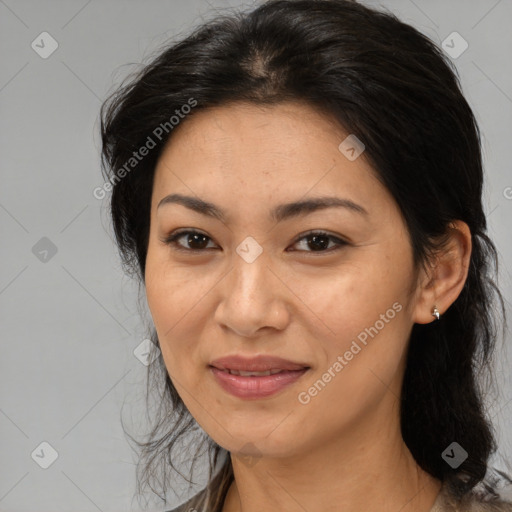 Joyful latino adult female with medium  brown hair and brown eyes