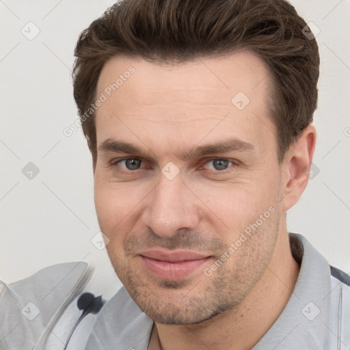 Joyful white adult male with short  brown hair and grey eyes