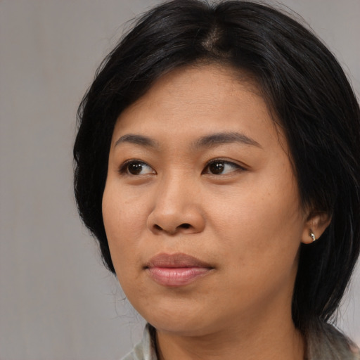 Joyful asian adult female with long  black hair and brown eyes